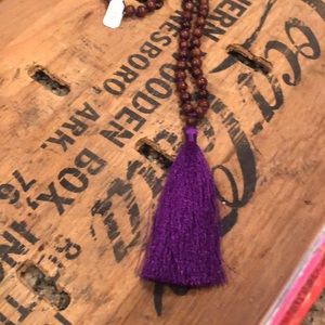Long wood beads with purple tassel